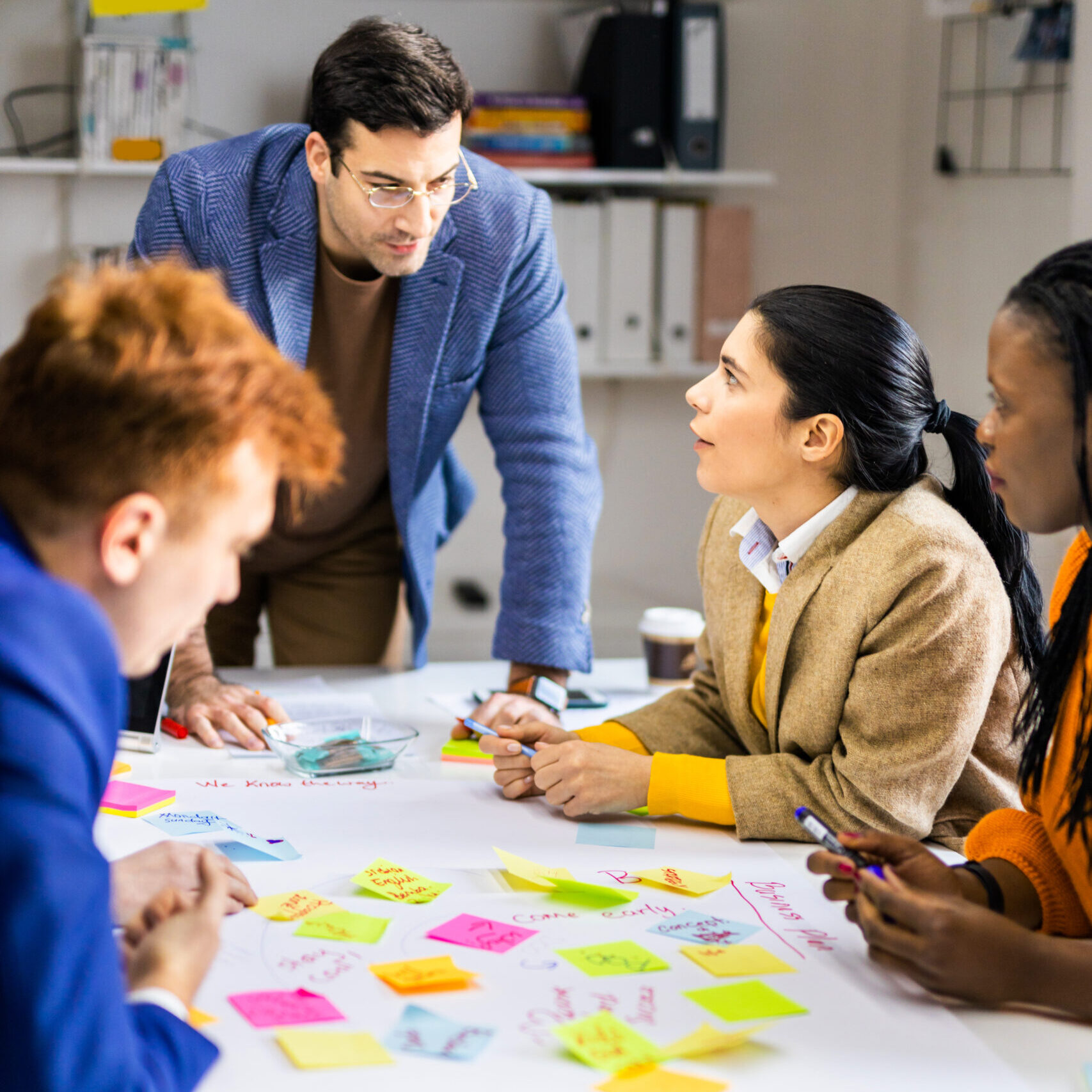 Team working through an AI use policy together at a table covered in sticky notes